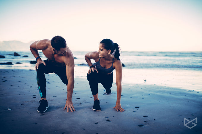  Couple on the beach getting ready to sprint. 